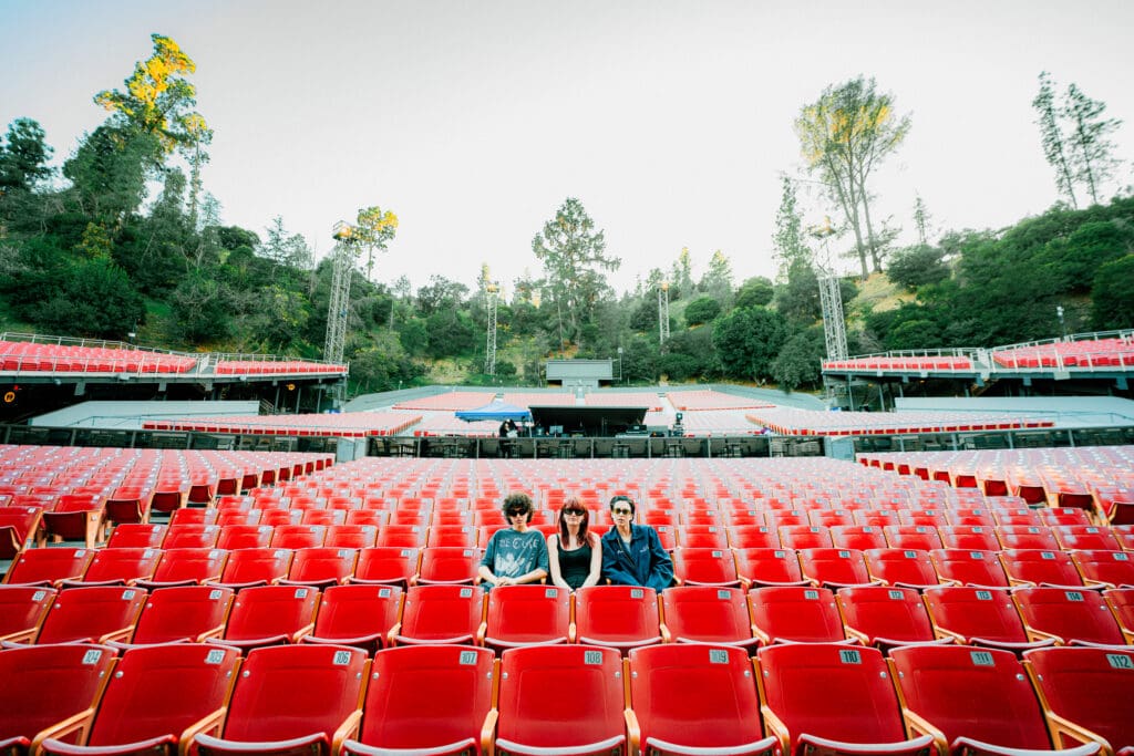 MUNA sitting in an empty Greek Theater